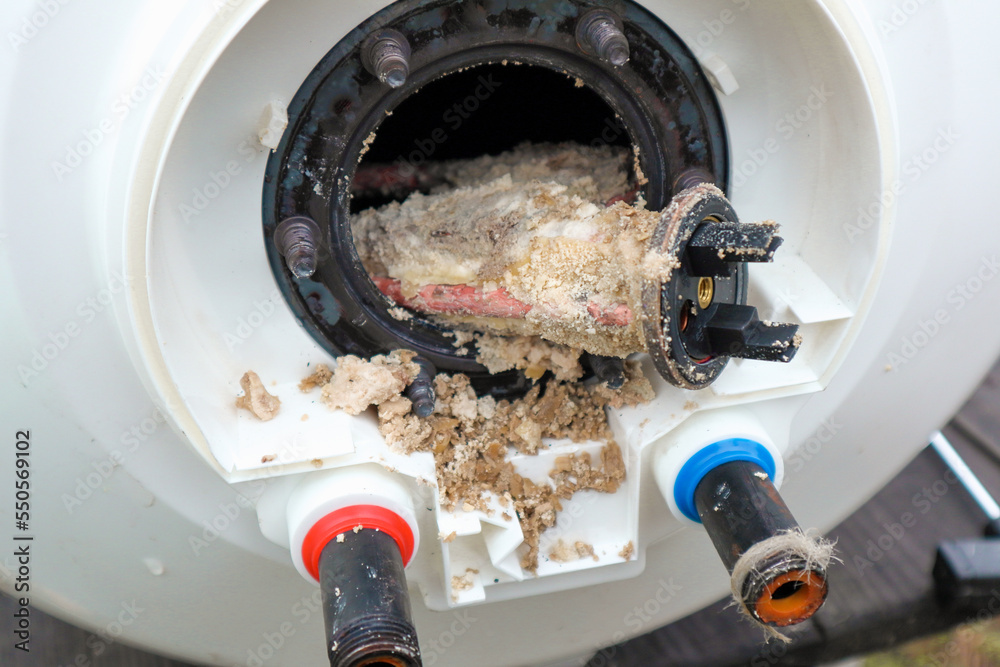 Technician repairing a water heater affected by limescale